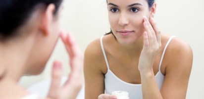 Woman applying skincare product