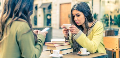 Two women using Facebook