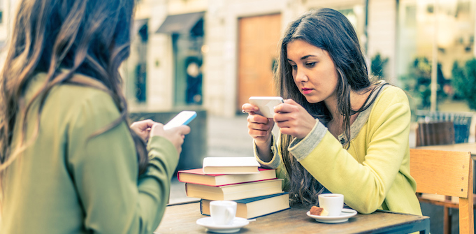 Two women using Facebook