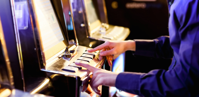 Man playing a pokie machine