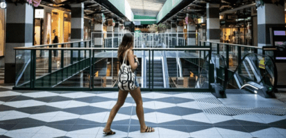 Woman standing in a shopping centre black friday