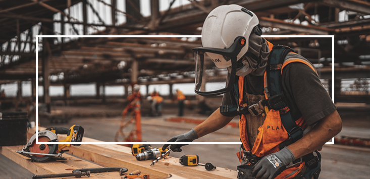 man using power tools in warehouse