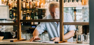 Man working behind the bar of a cafe bar